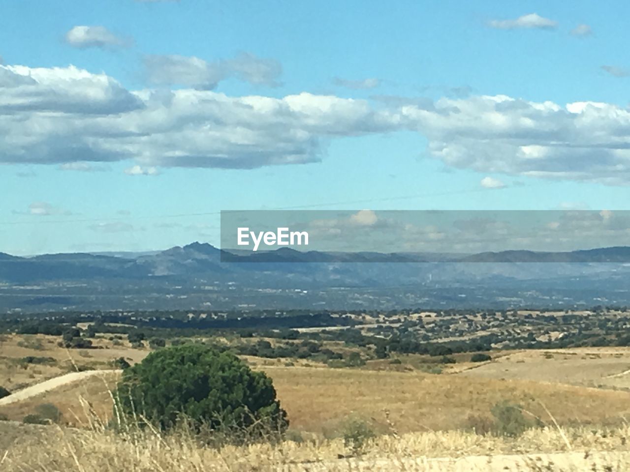 SCENIC VIEW OF FIELD AND MOUNTAINS AGAINST SKY
