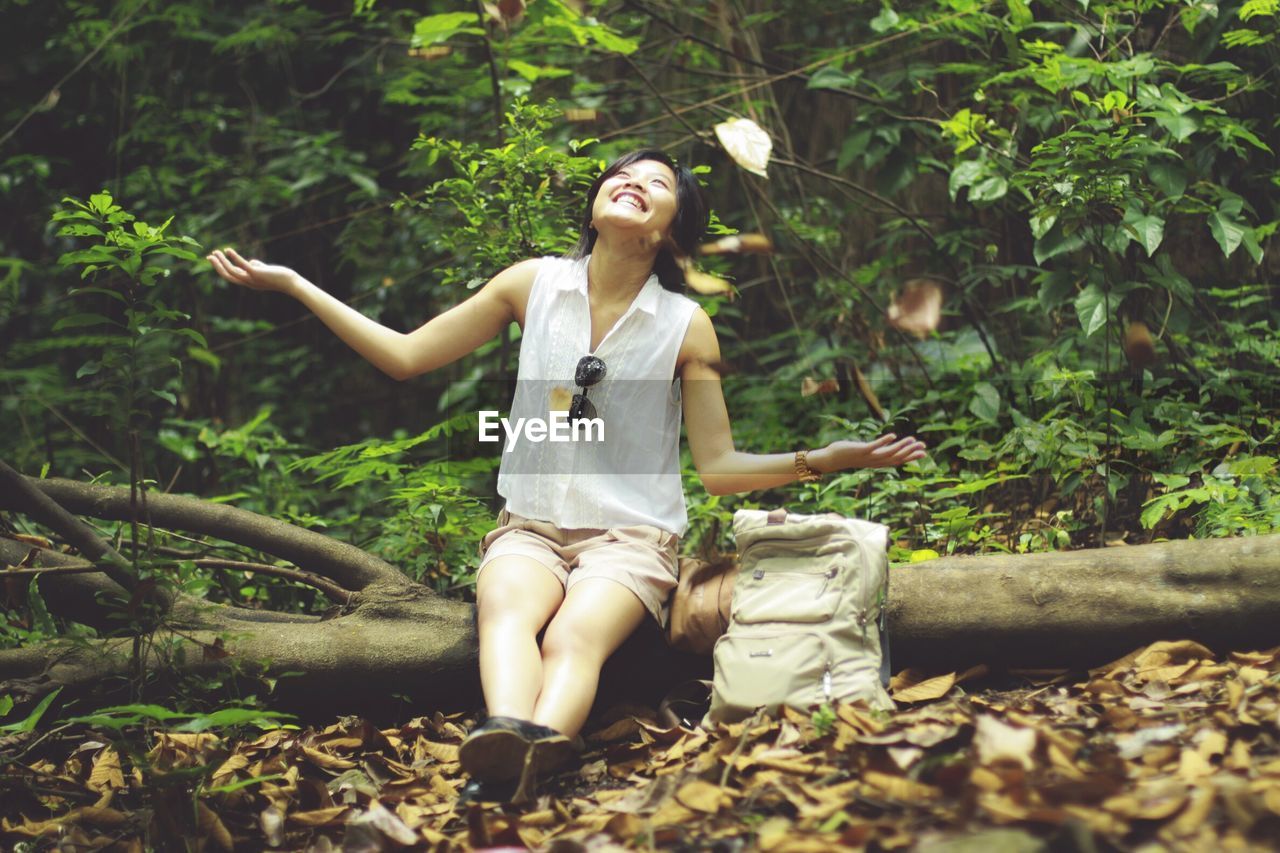 Woman sitting in forest