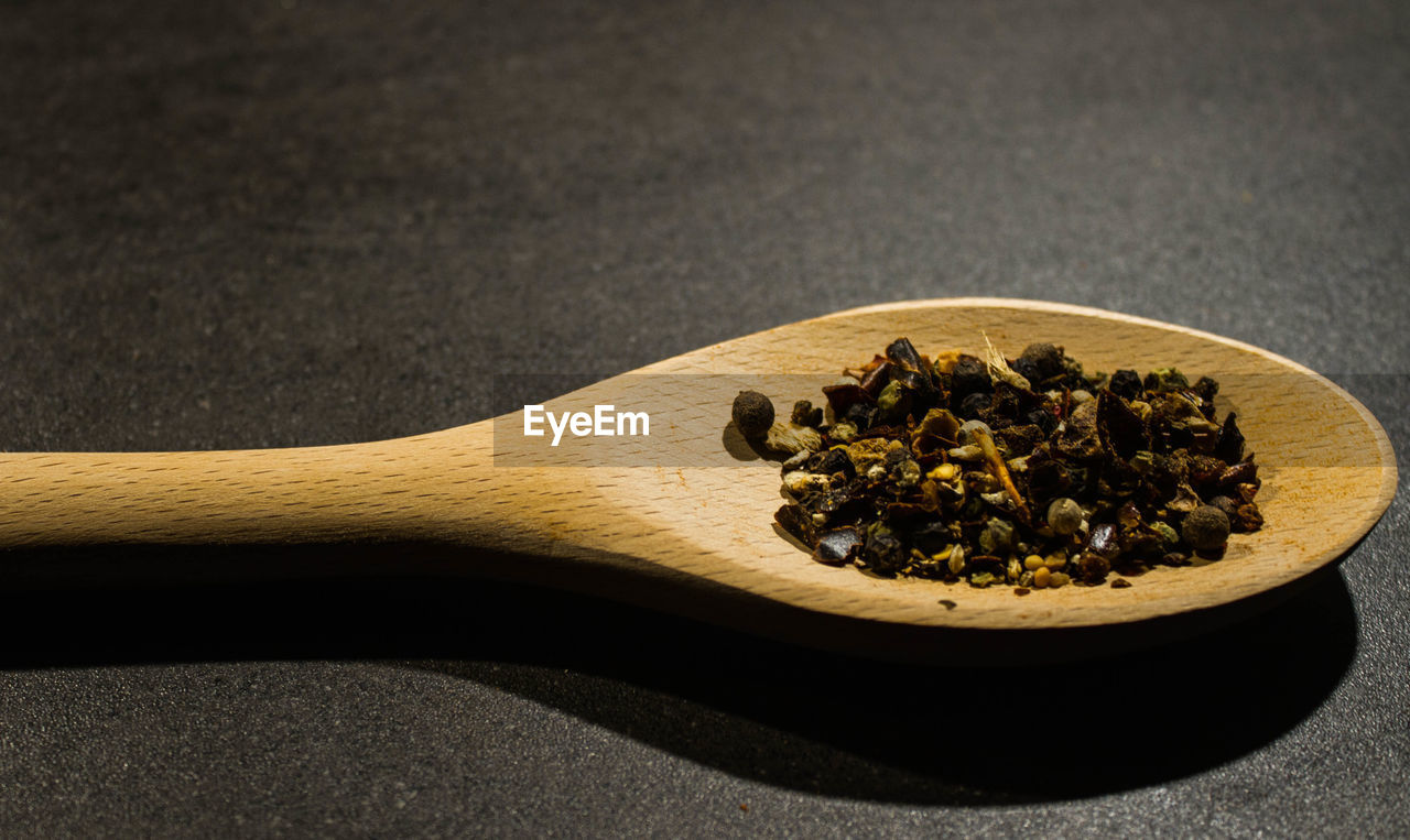 Close-up of spice in wooden spoon on table