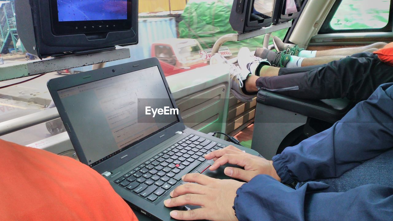 technology, computer, computer equipment, communication, adult, laptop, wireless technology, working, computer monitor, sitting, one person, occupation, men, using computer, indoors, furniture, business, computer keyboard, person, internet, desktop pc, personal computer, keyboard, control, transportation, business finance and industry, using laptop, mode of transportation, computer network