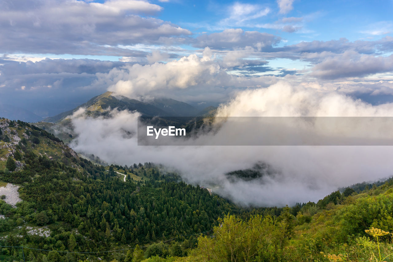 High angle view of mountains against cloudy sky