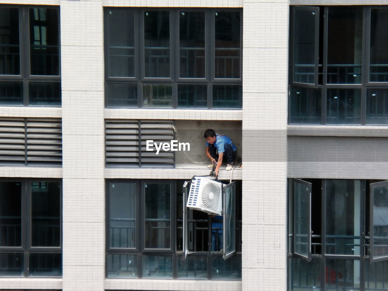 WOMAN STANDING ON BUILDING