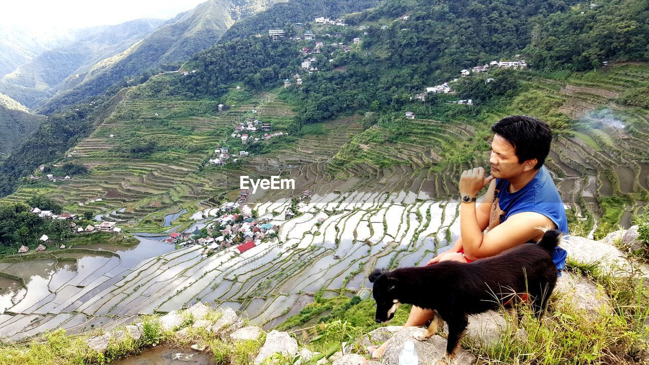 Man sitting on terraced field