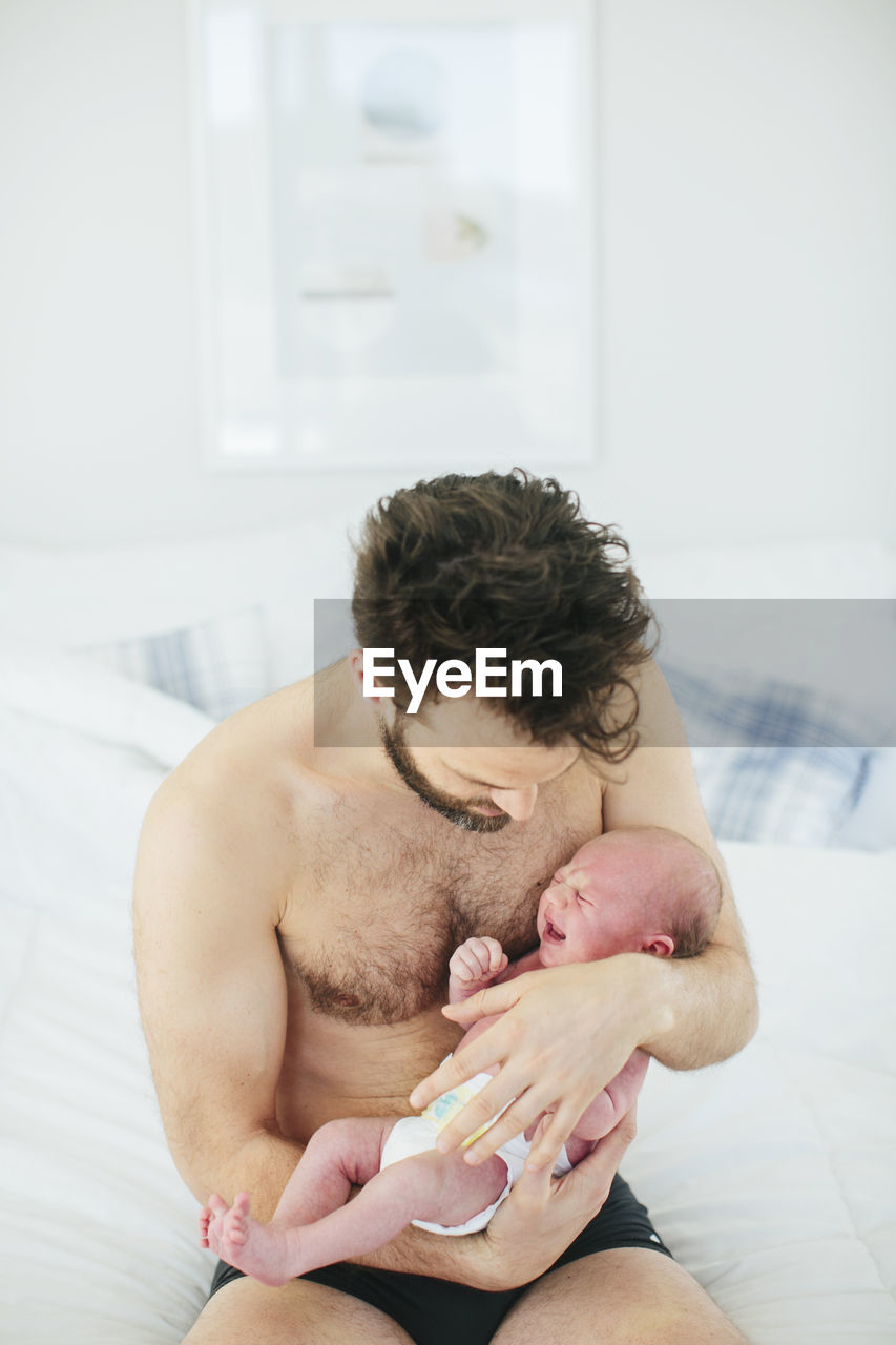 Mid adult man with newborn baby