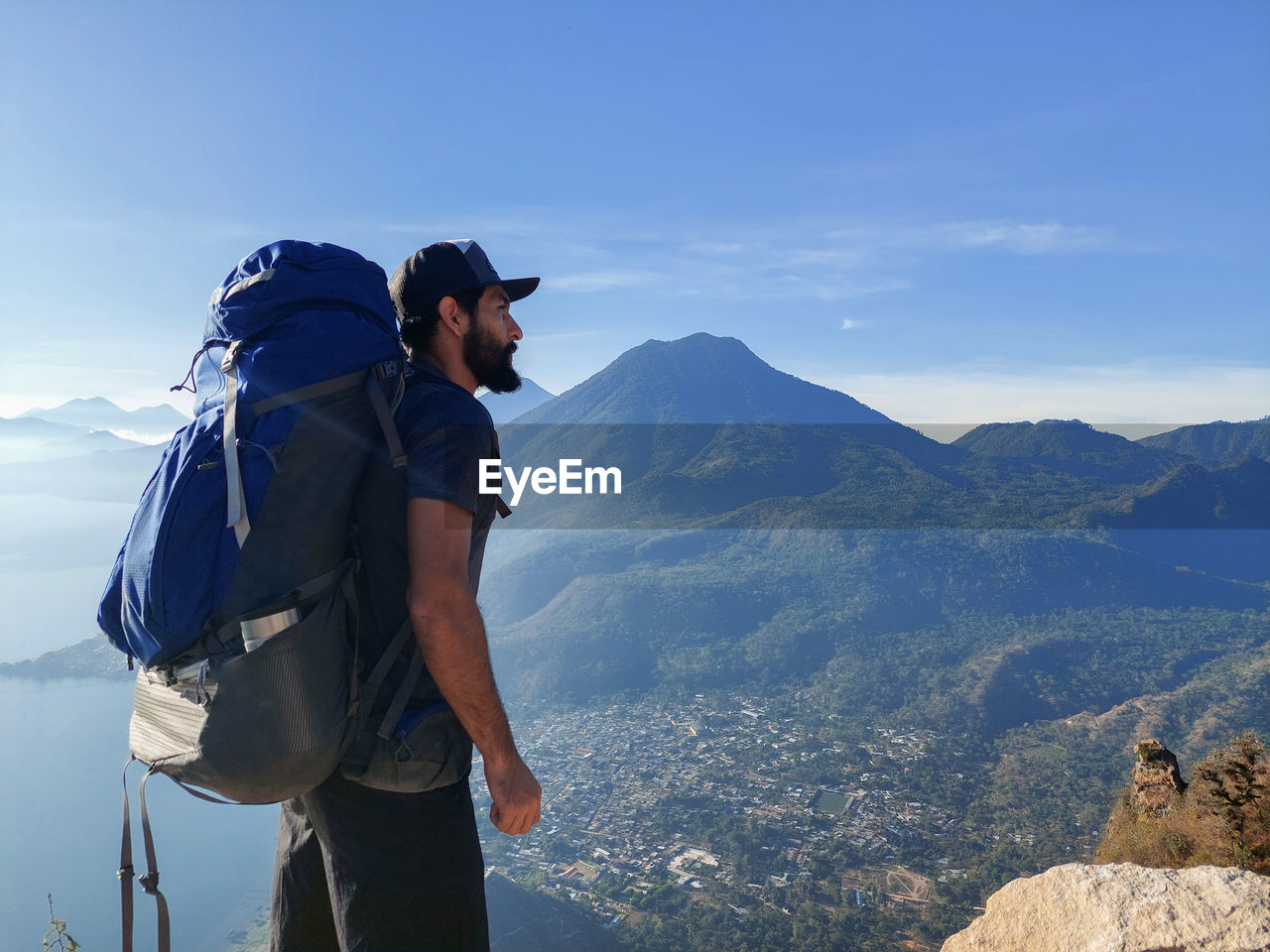 Rear view of woman standing on mountain against sky