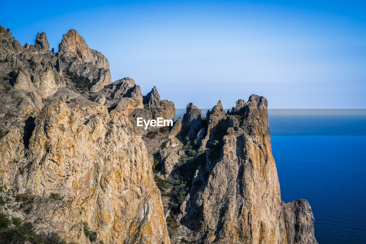 Sheer cliffs near the sea of the volcanic formation karadag in koktebel crimea