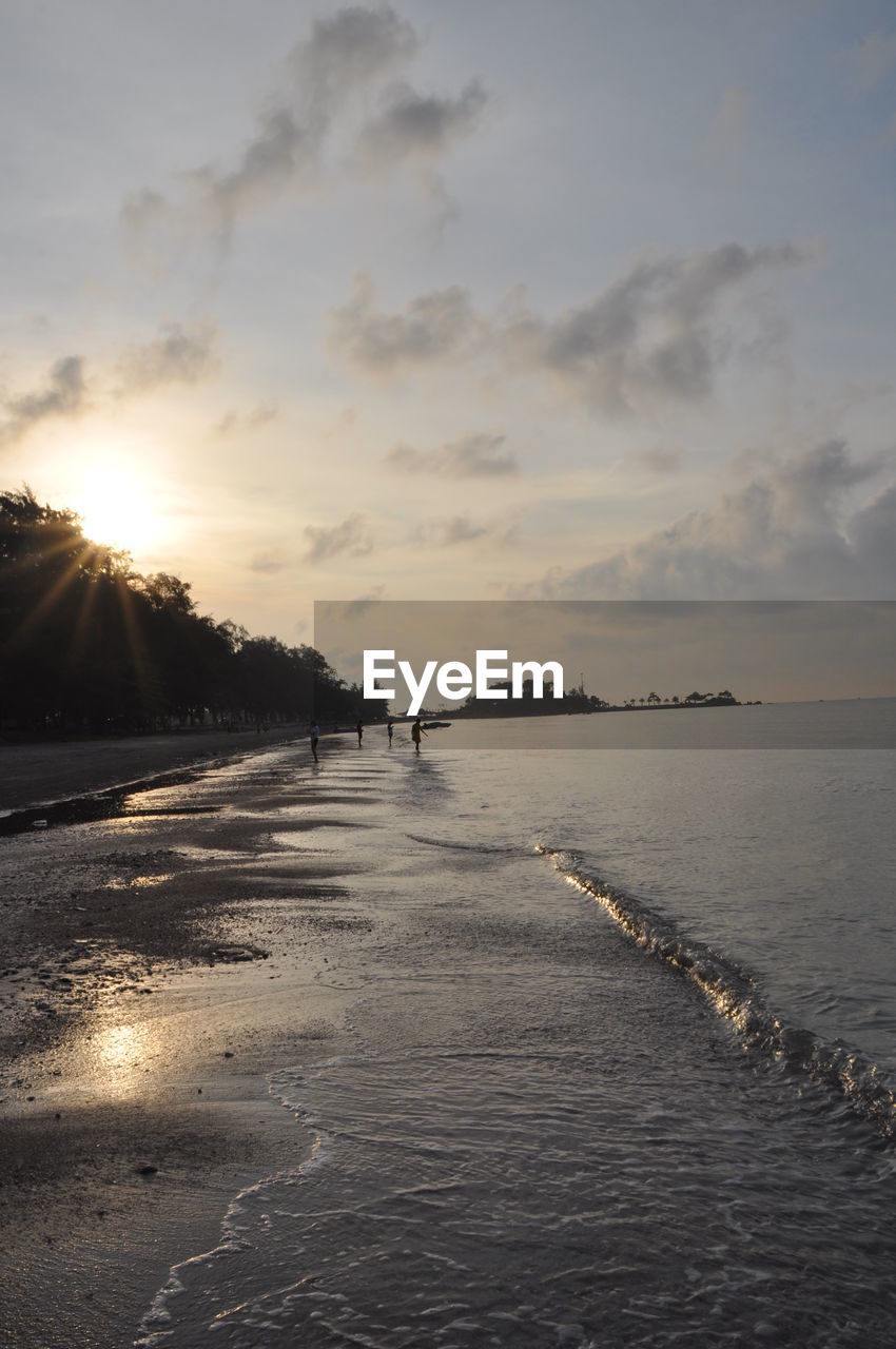 Scenic view of beach against sky during sunset