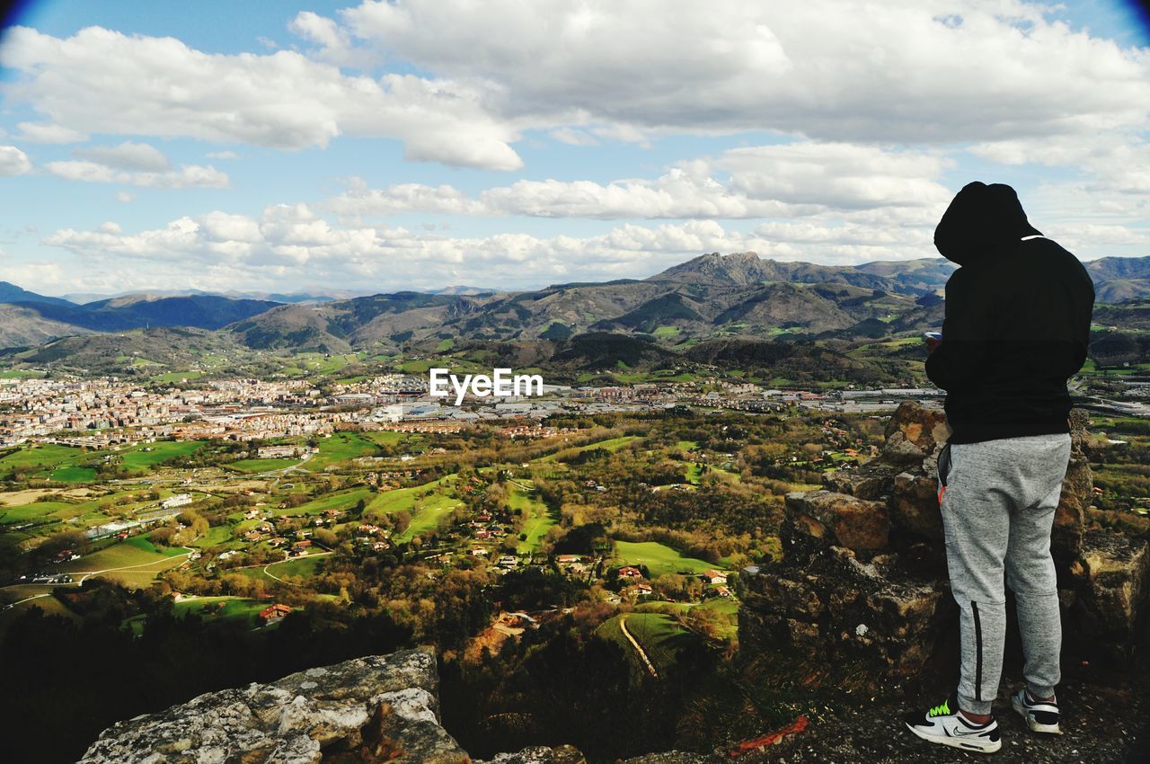 WOMAN LOOKING AT MOUNTAINS