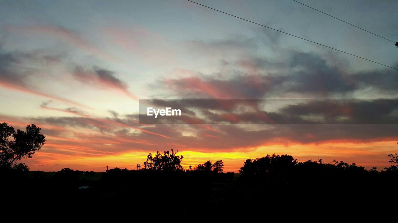 Silhouette landscape against sky during sunset