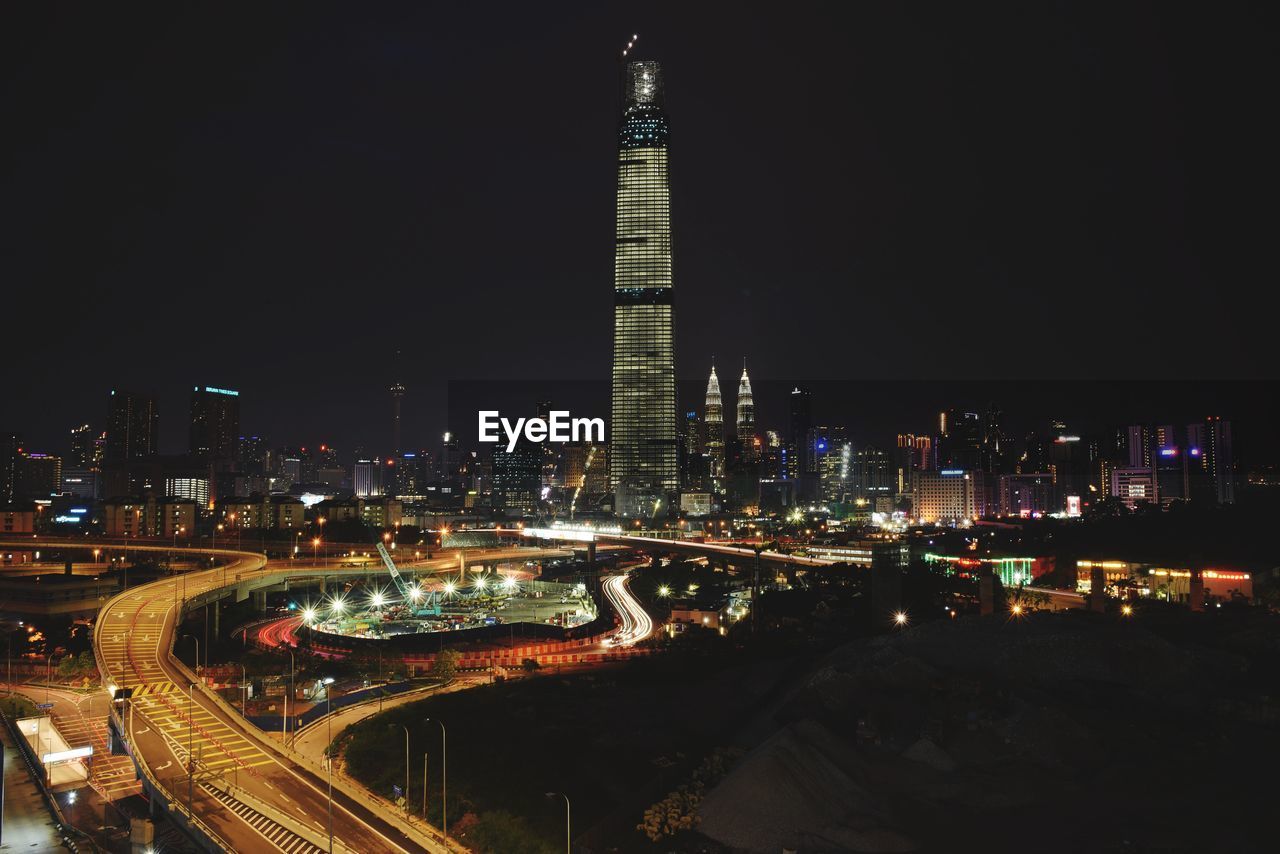 High angle view of illuminated buildings against sky at night