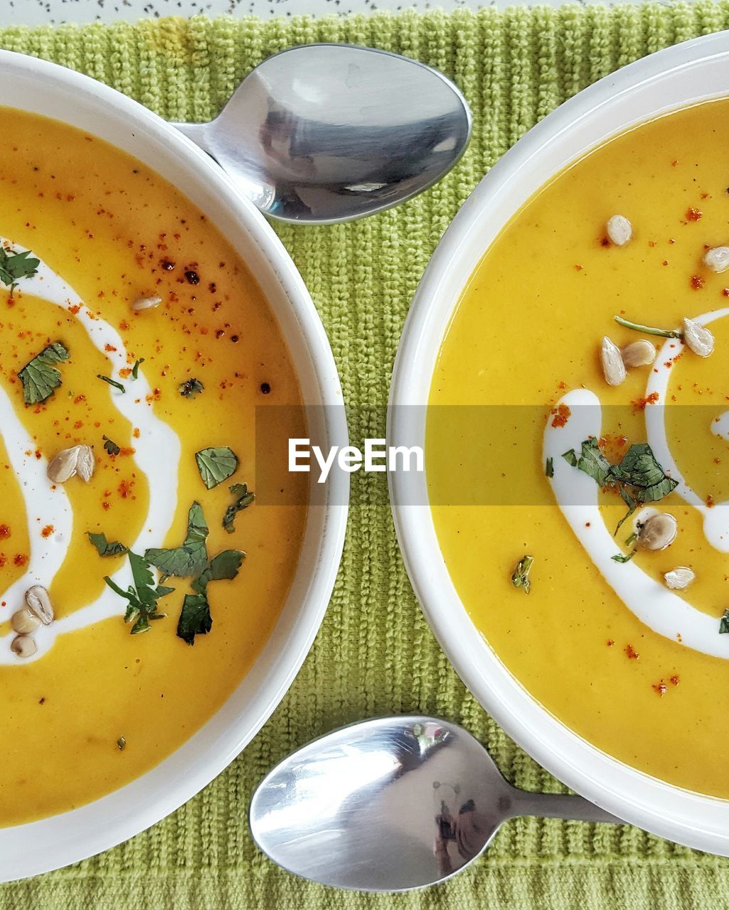 Directly above shot of soup served in bowls on table