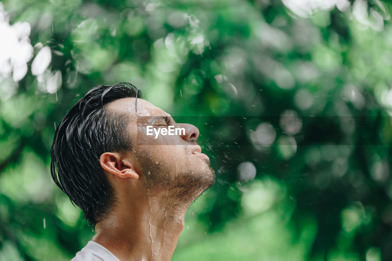 Man with eyes closed at park