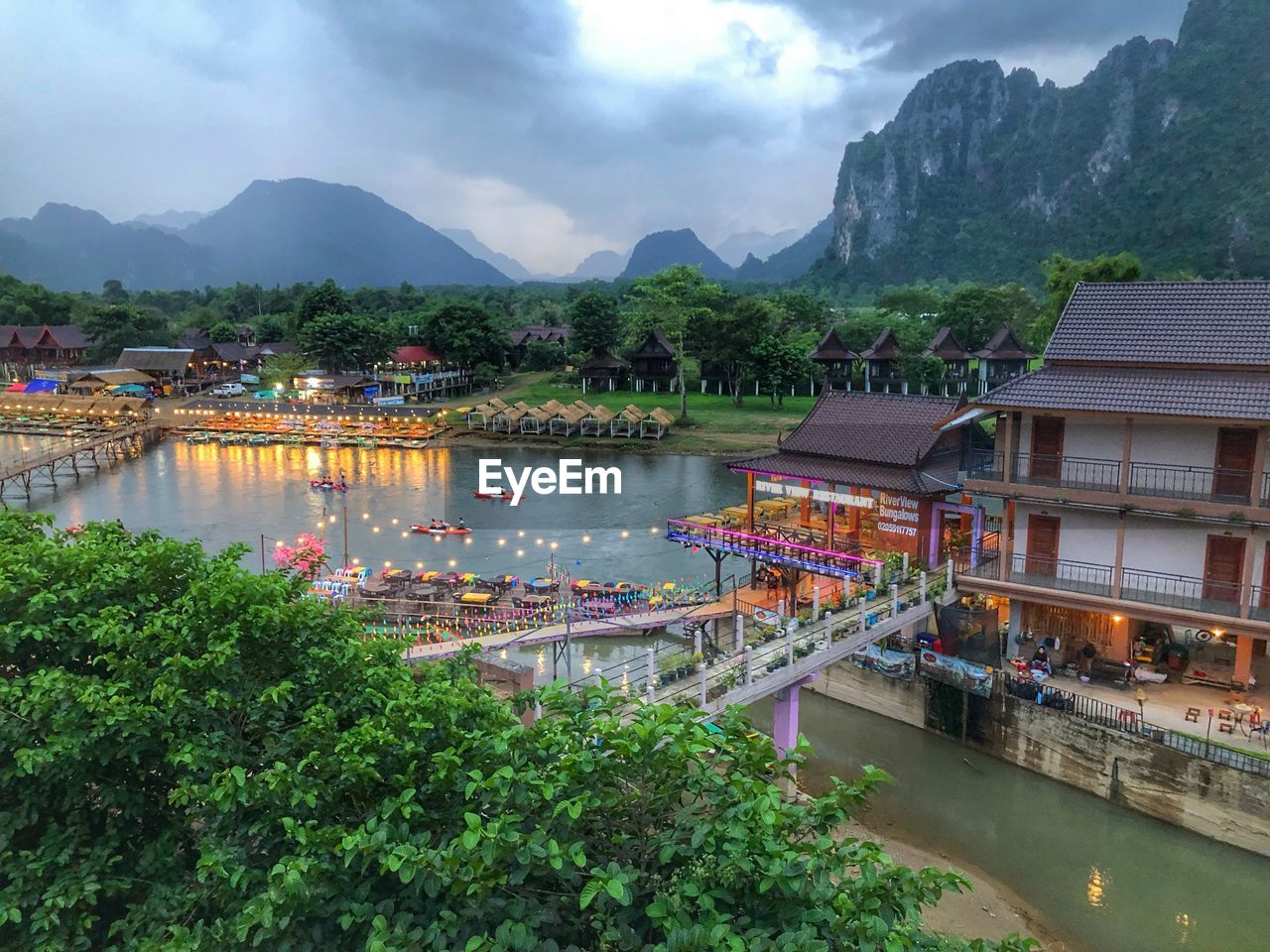 Scenic view of lake by buildings against mountains