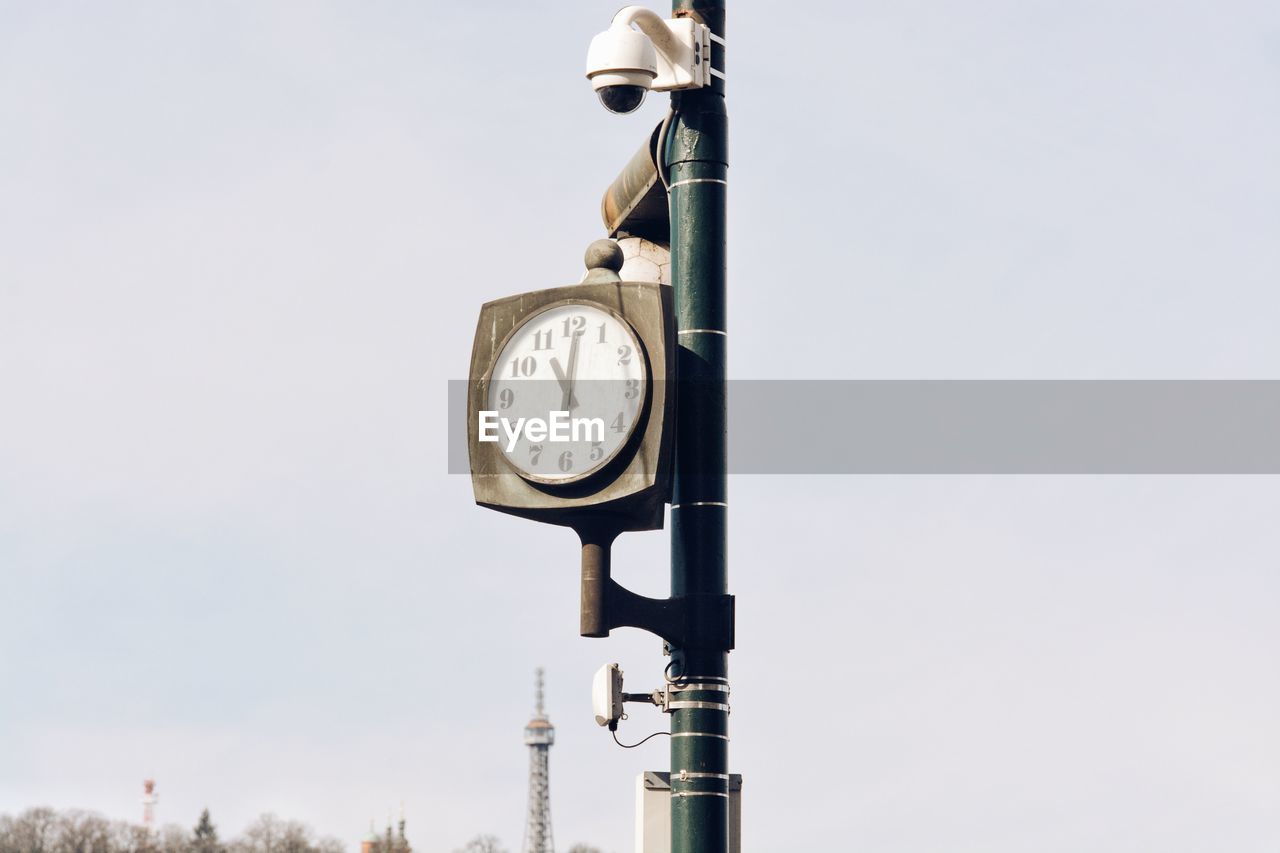 Low angle view of clock against clear sky