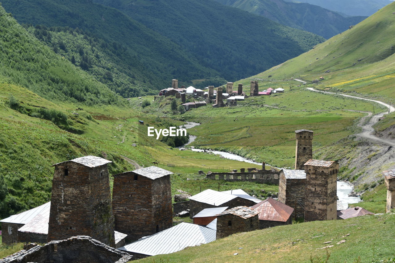 High angle view of village amidst houses and mountains