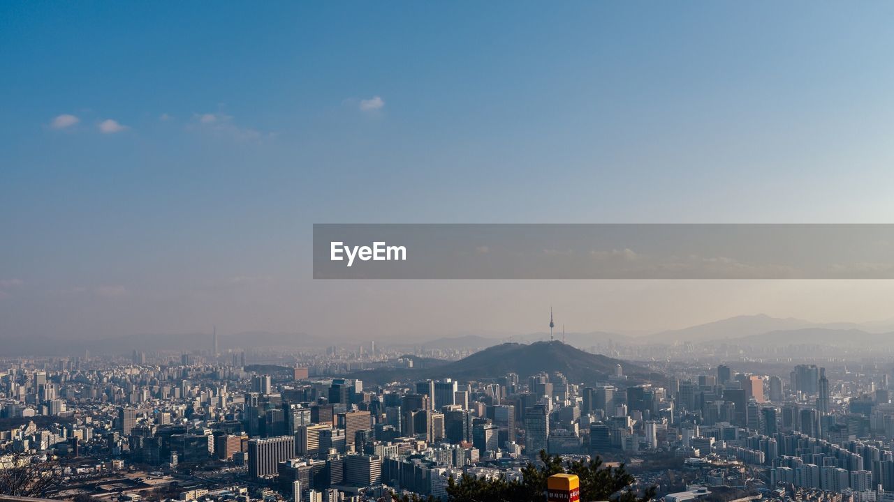 High angle view of modern buildings in city against sky