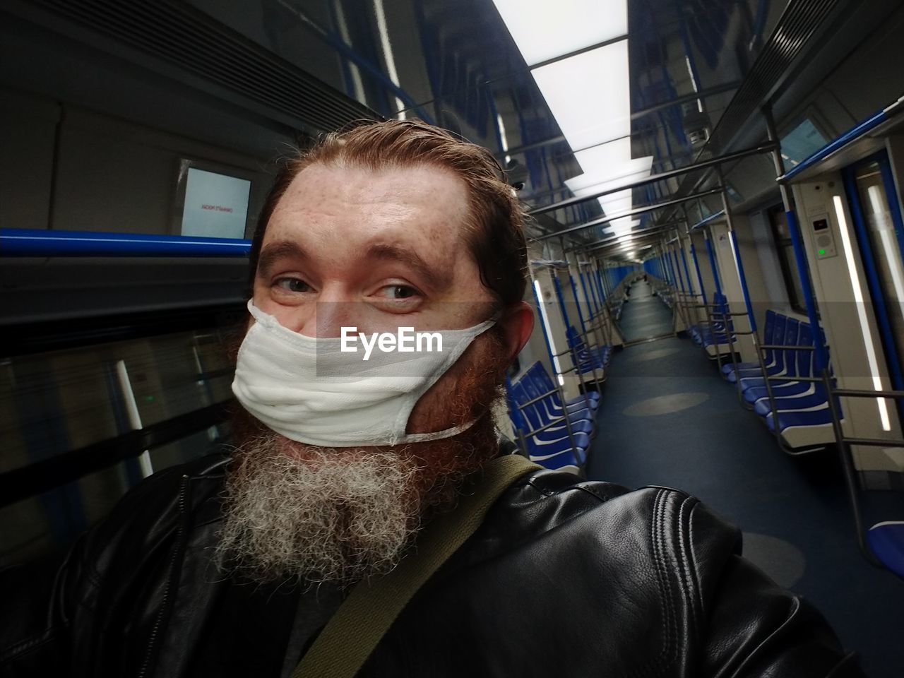 PORTRAIT OF MAN WEARING MASK IN CORRIDOR