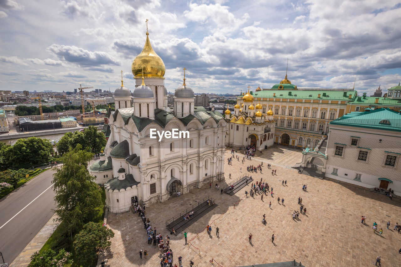 HIGH ANGLE VIEW OF BUILDINGS AGAINST CLOUDY SKY