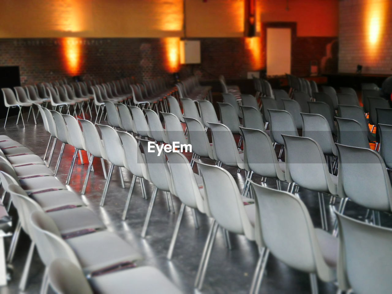 Empty chairs in illuminated seminar hall
