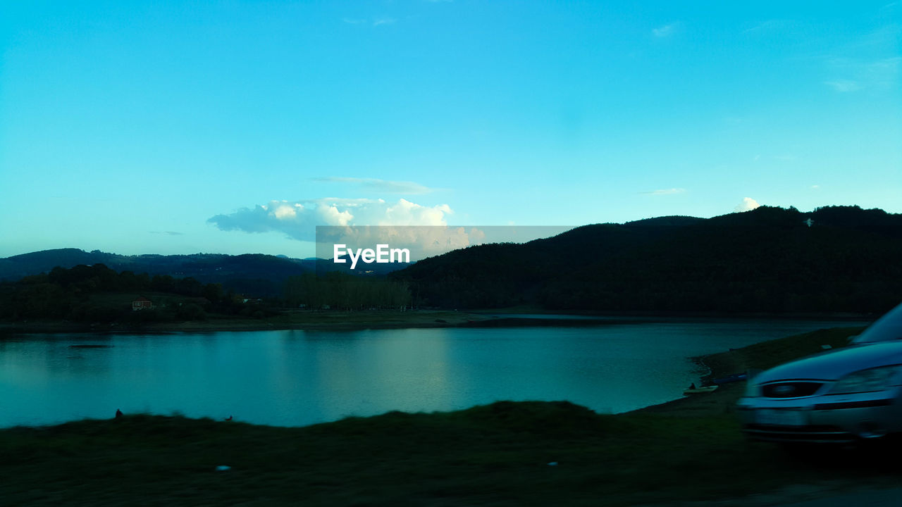 SCENIC VIEW OF LAKE AGAINST BLUE SKY