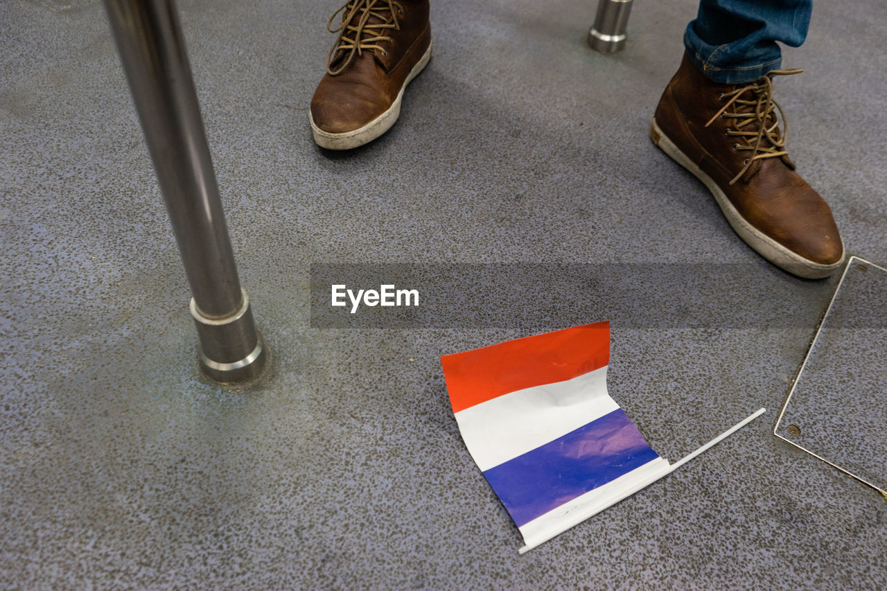 Low section of person by flag on ground