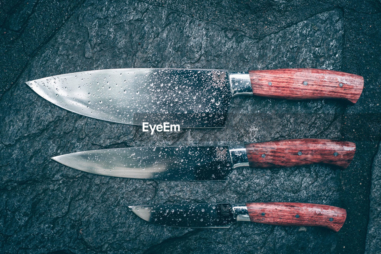 knife, weapon, tool, utility knife, no people, still life, melee weapon, high angle view, directly above, hunting knife, indoors, cold weapon, close-up, wood