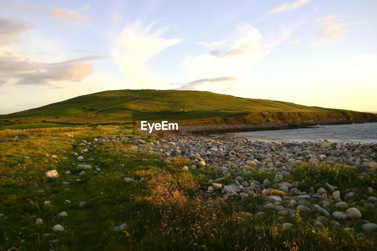 Scenic view of water on land against sky