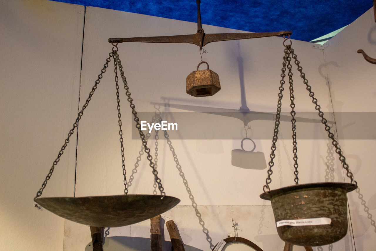 LOW ANGLE VIEW OF LIGHTING EQUIPMENT HANGING ON WALL