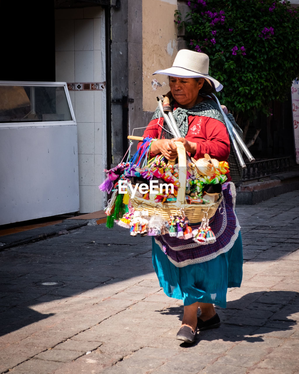 FULL LENGTH OF MAN HOLDING HAT