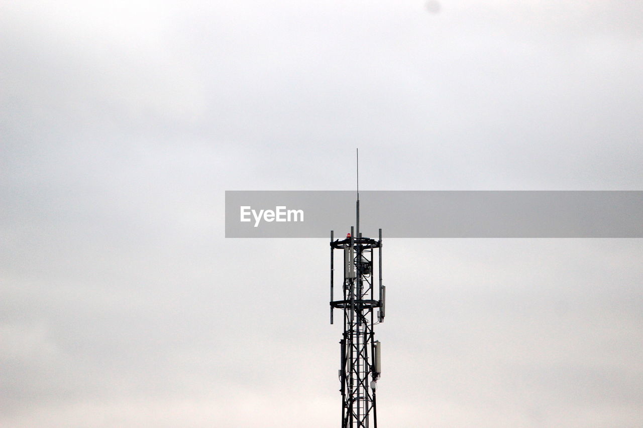 Low angle view of communications tower against sky