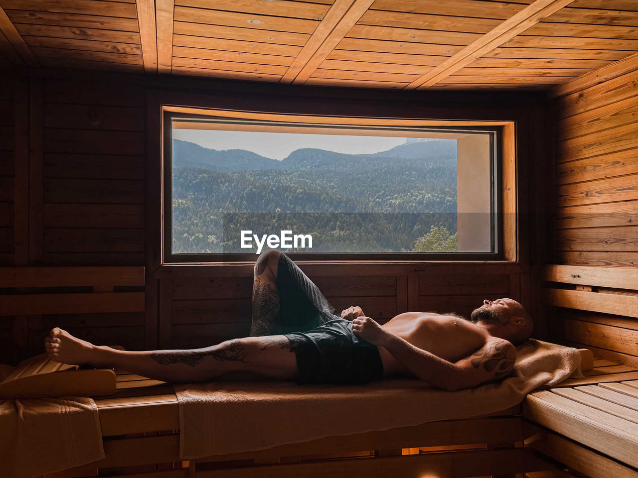 Man laying down in a sauna