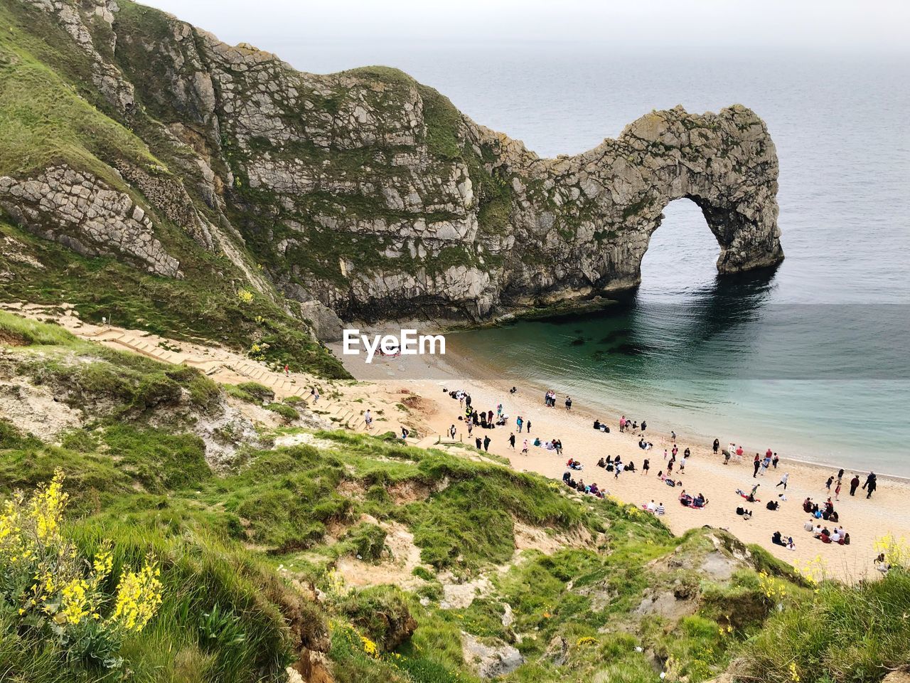 HIGH ANGLE VIEW OF ROCKS ON BEACH AGAINST SKY