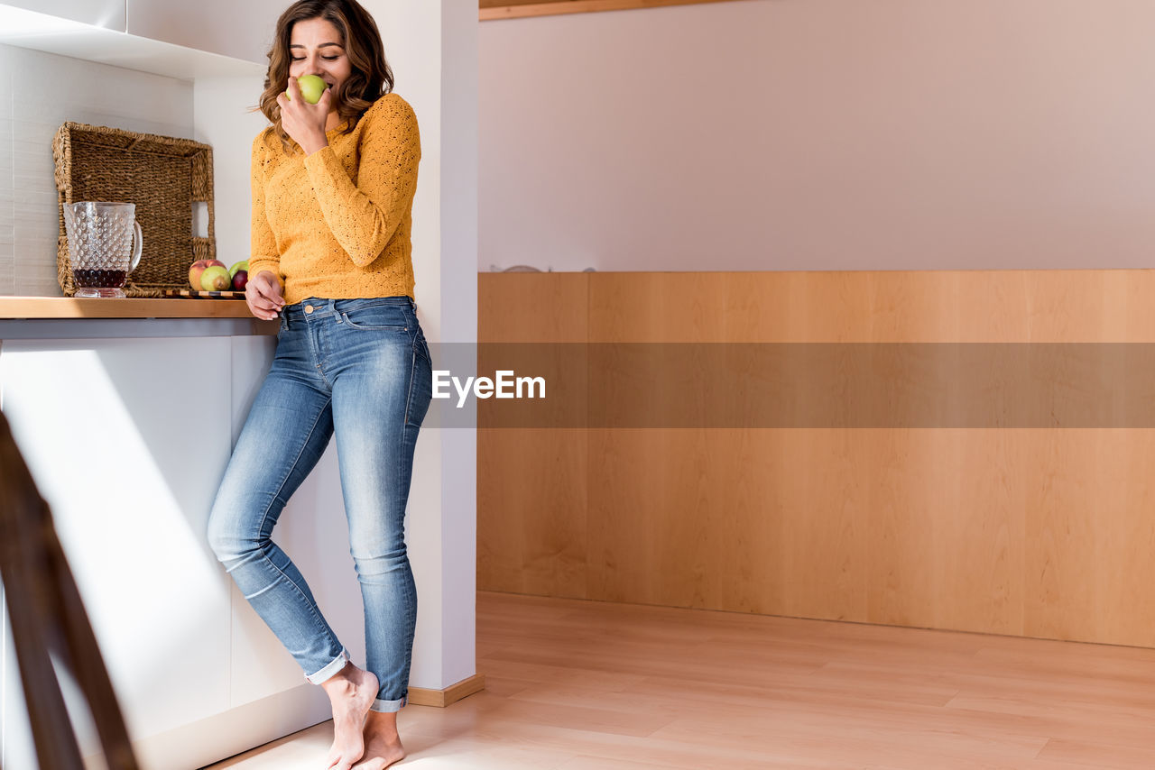 WOMAN STANDING IN FRONT OF HOME