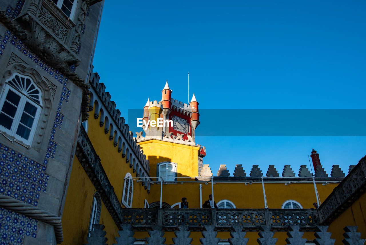 Low angle view of buildings against blue sky