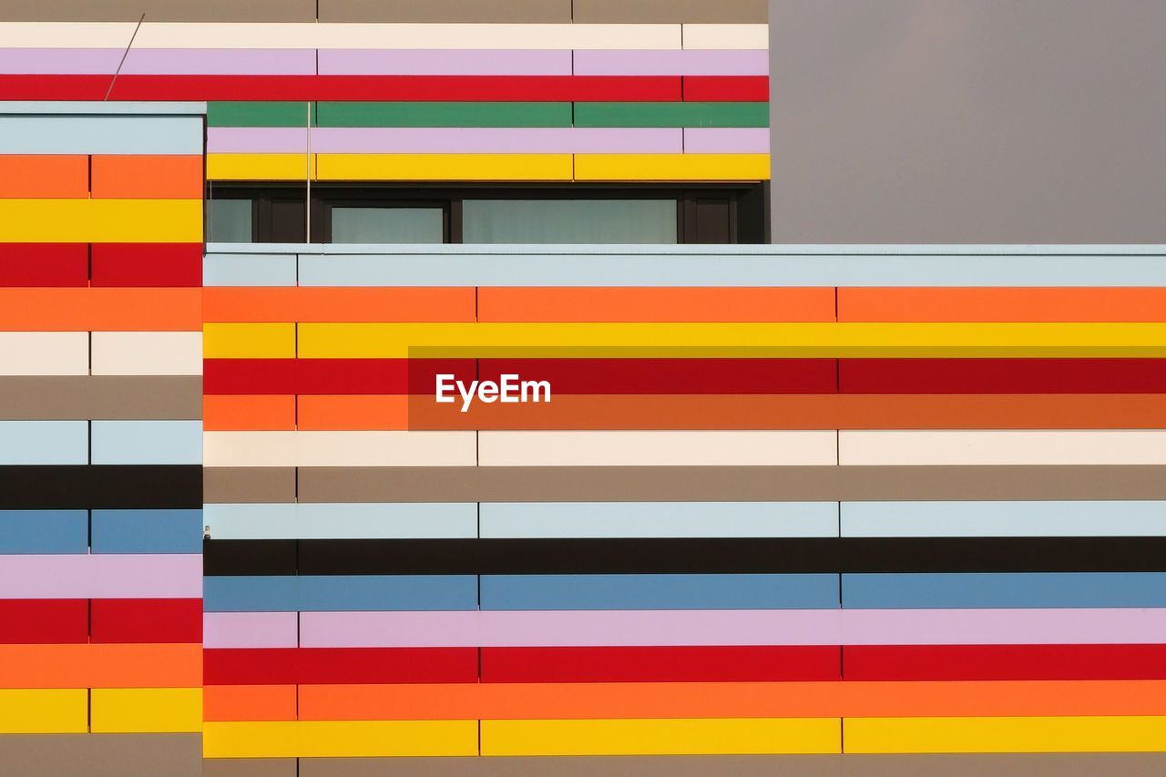 Multi colored building wall with window of meininger hotel berlin airport