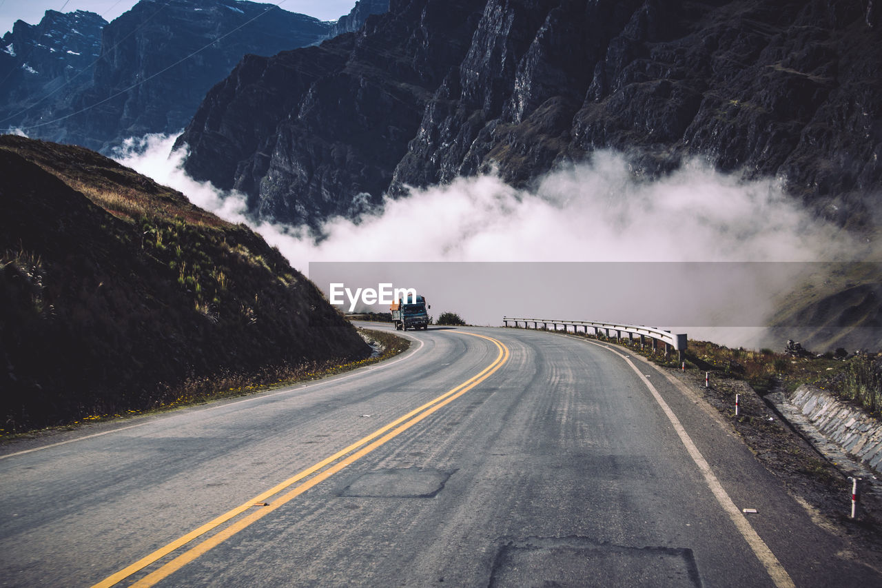 Truck on country road against mountains
