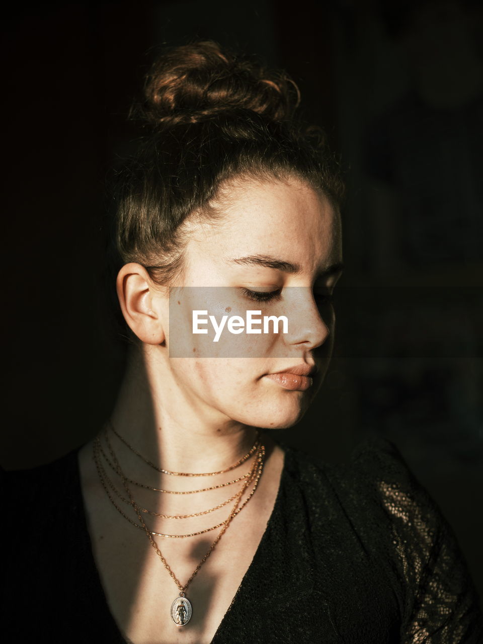 Close-up portrait of a young woman looking away