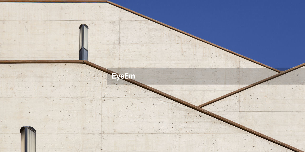 LOW ANGLE VIEW OF WHITE BUILDING AGAINST BLUE SKY