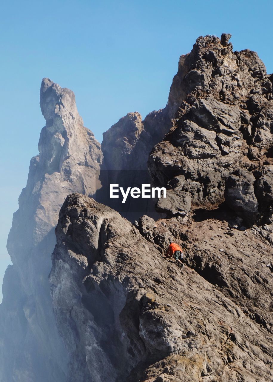 Rock formations on mountain against clear sky