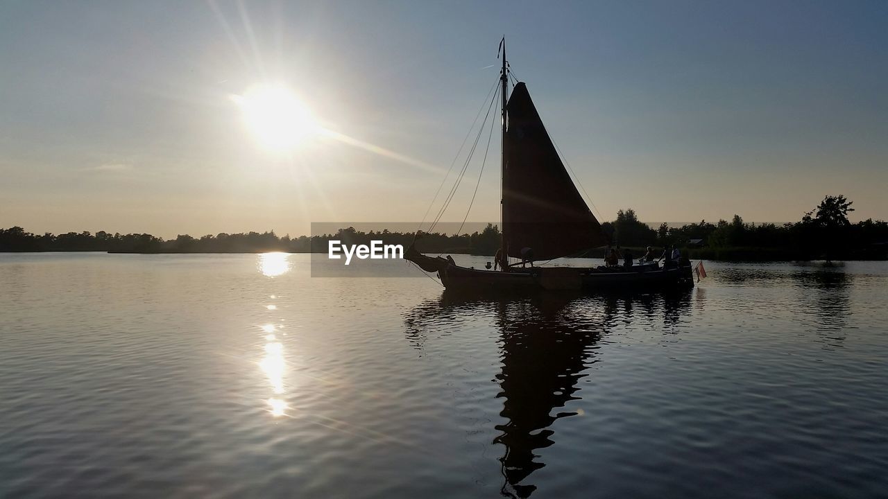 SILHOUETTE OF BOAT IN WATER