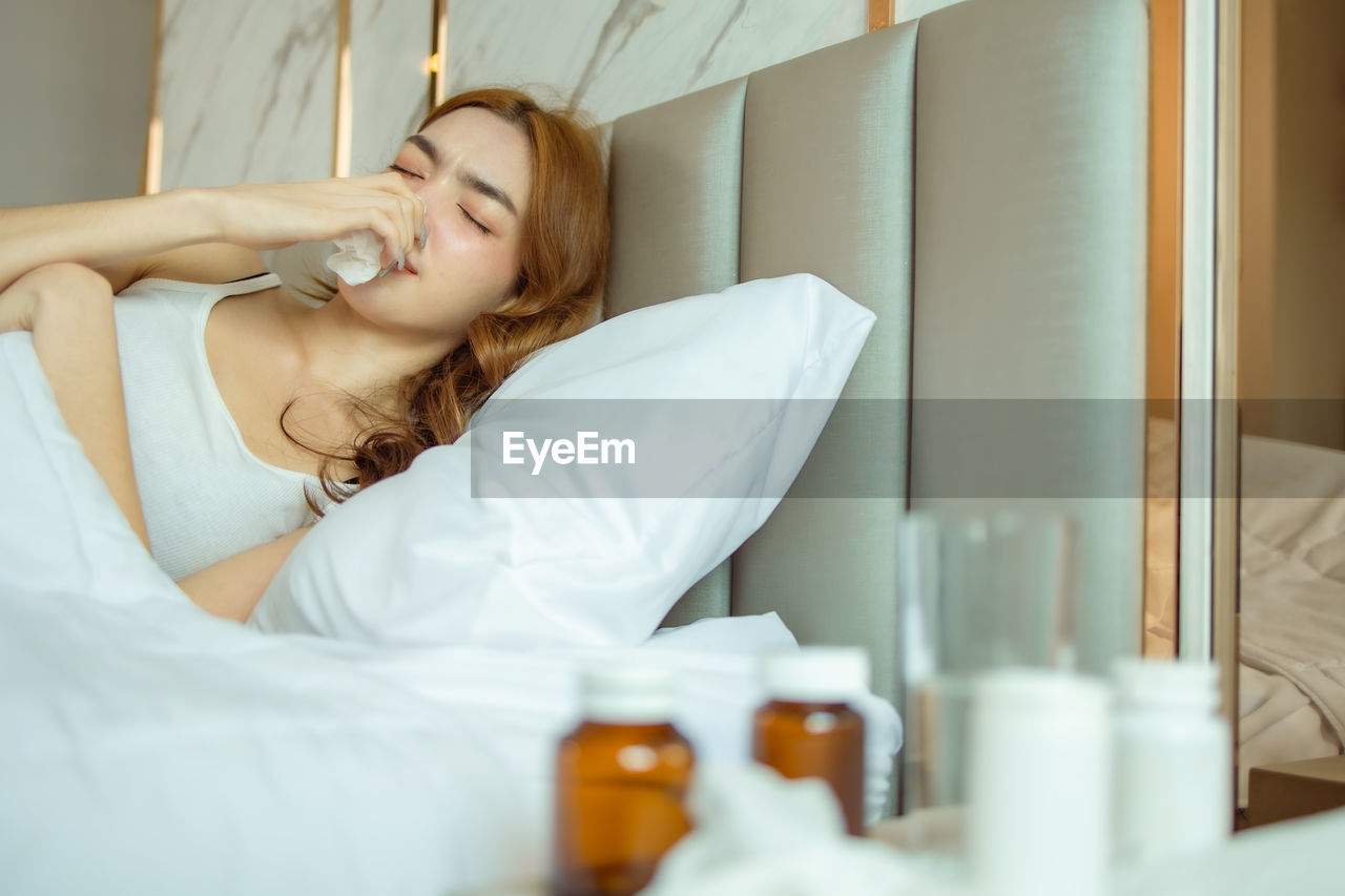 Portrait of woman relaxing on bed at home