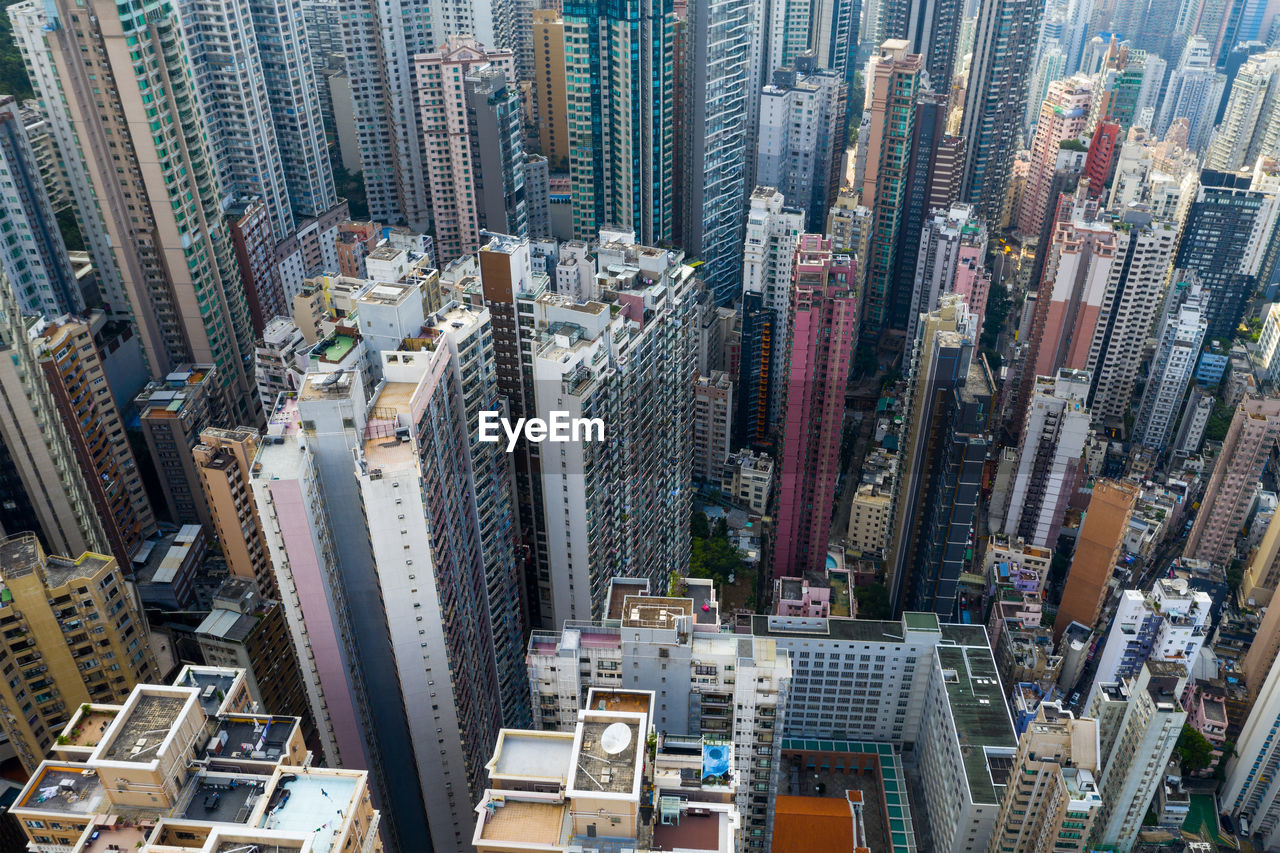 HIGH ANGLE VIEW OF MODERN BUILDINGS IN CITY AT NIGHT