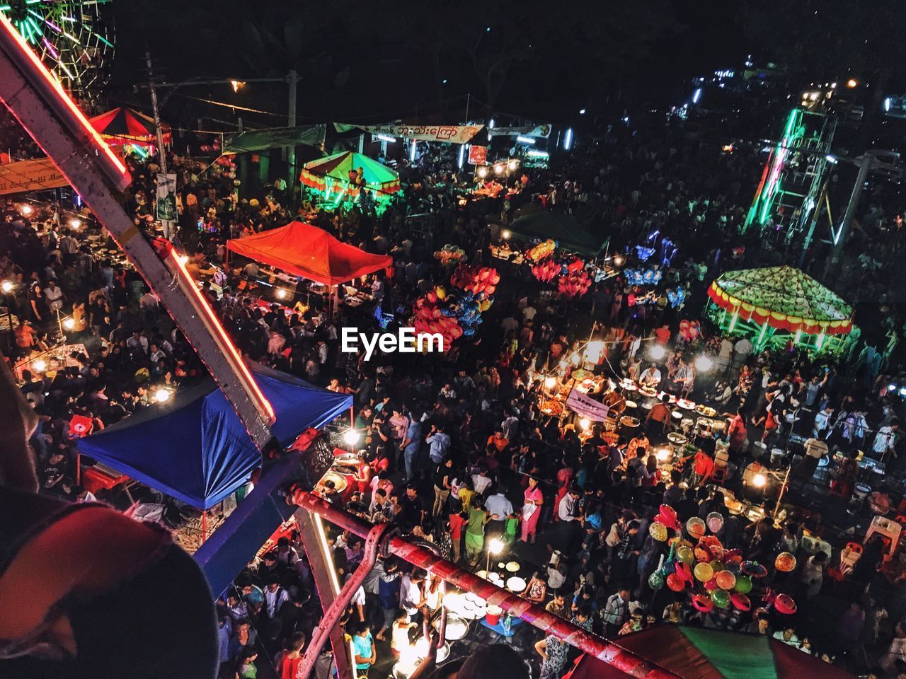 High angle view of people at amusement park at night