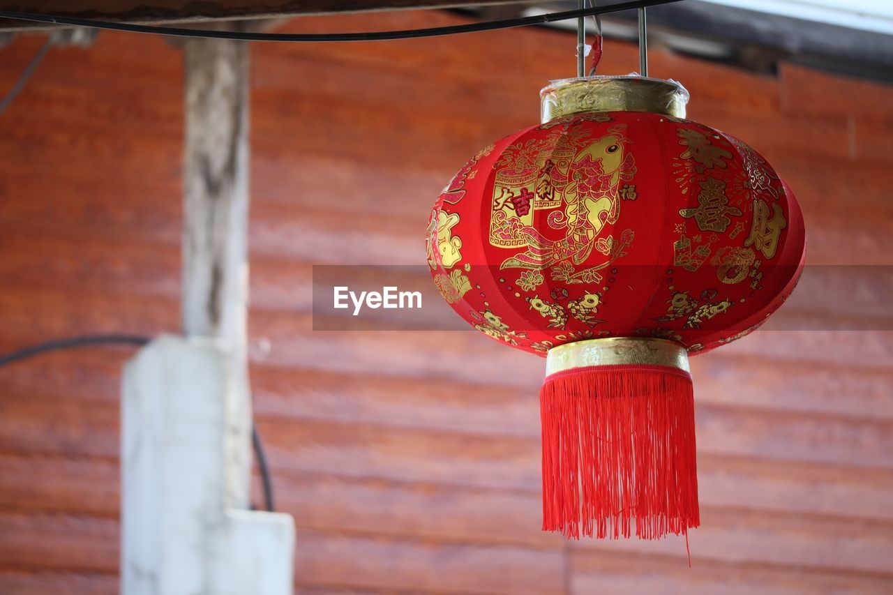 Low angle view of lanterns hanging by building