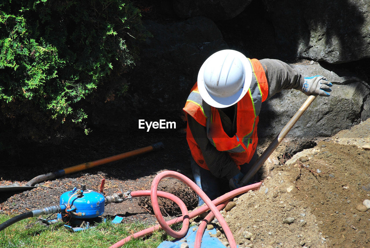 HIGH ANGLE VIEW OF PEOPLE WORKING BY PLANT