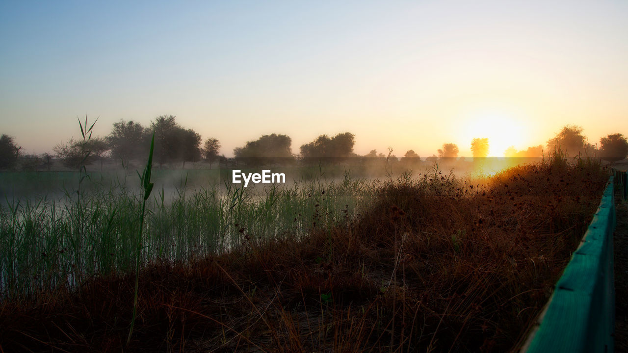 SCENIC VIEW OF SUNSET OVER LAND