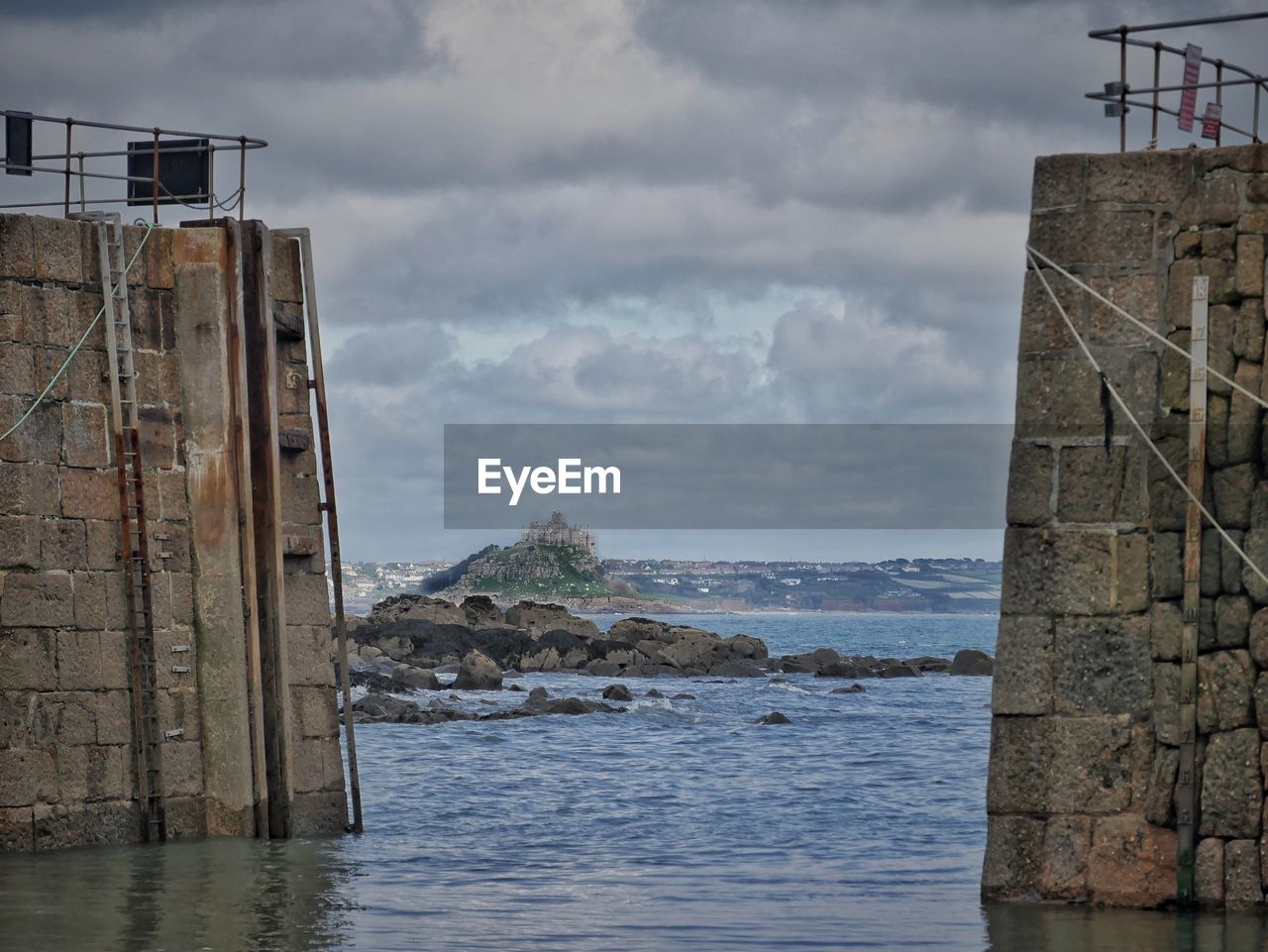 water, sea, coast, architecture, tower, sky, built structure, cloud, ocean, nature, rock, shore, building exterior, beach, reflection, land, cliff, no people, building, waterway, outdoors, day, bay, terrain, coastline, travel