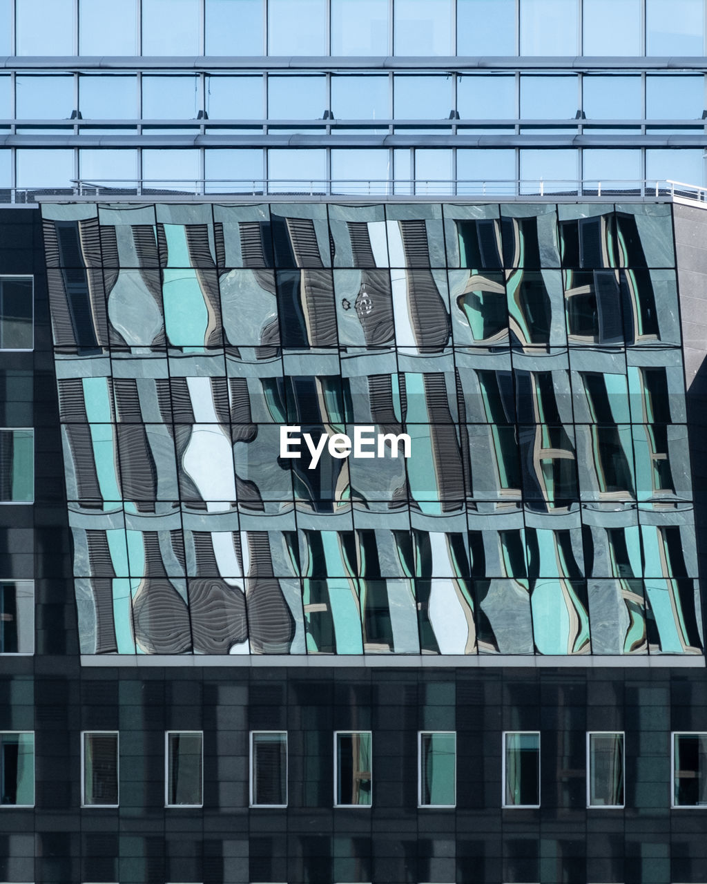 Low angle view of glass building against sky