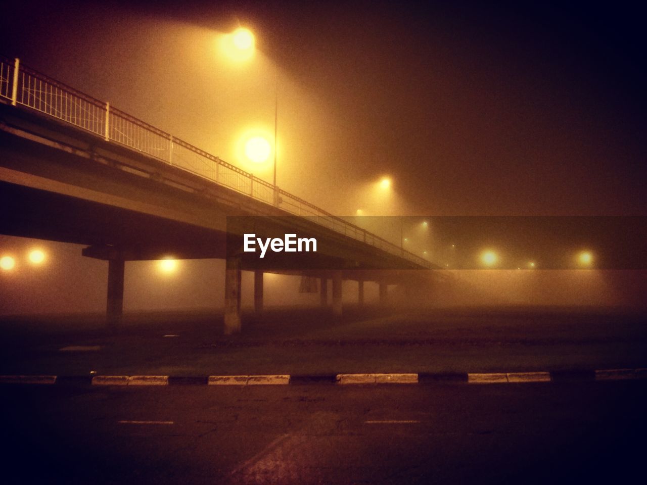 BRIDGE OVER RIVER AT NIGHT