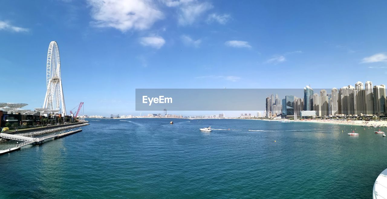 Panoramic view of sea and buildings against sky